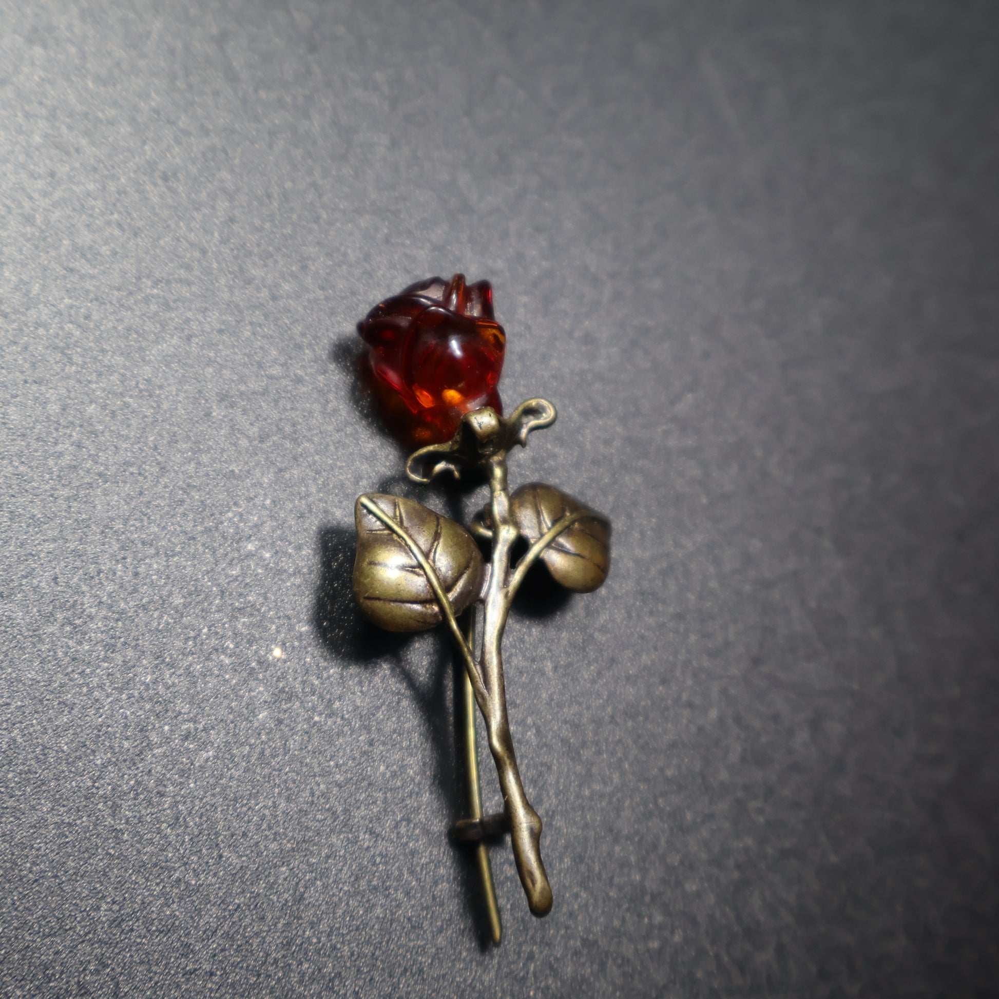 Handmade Baltic amber rose brooch close-up showing natural stone