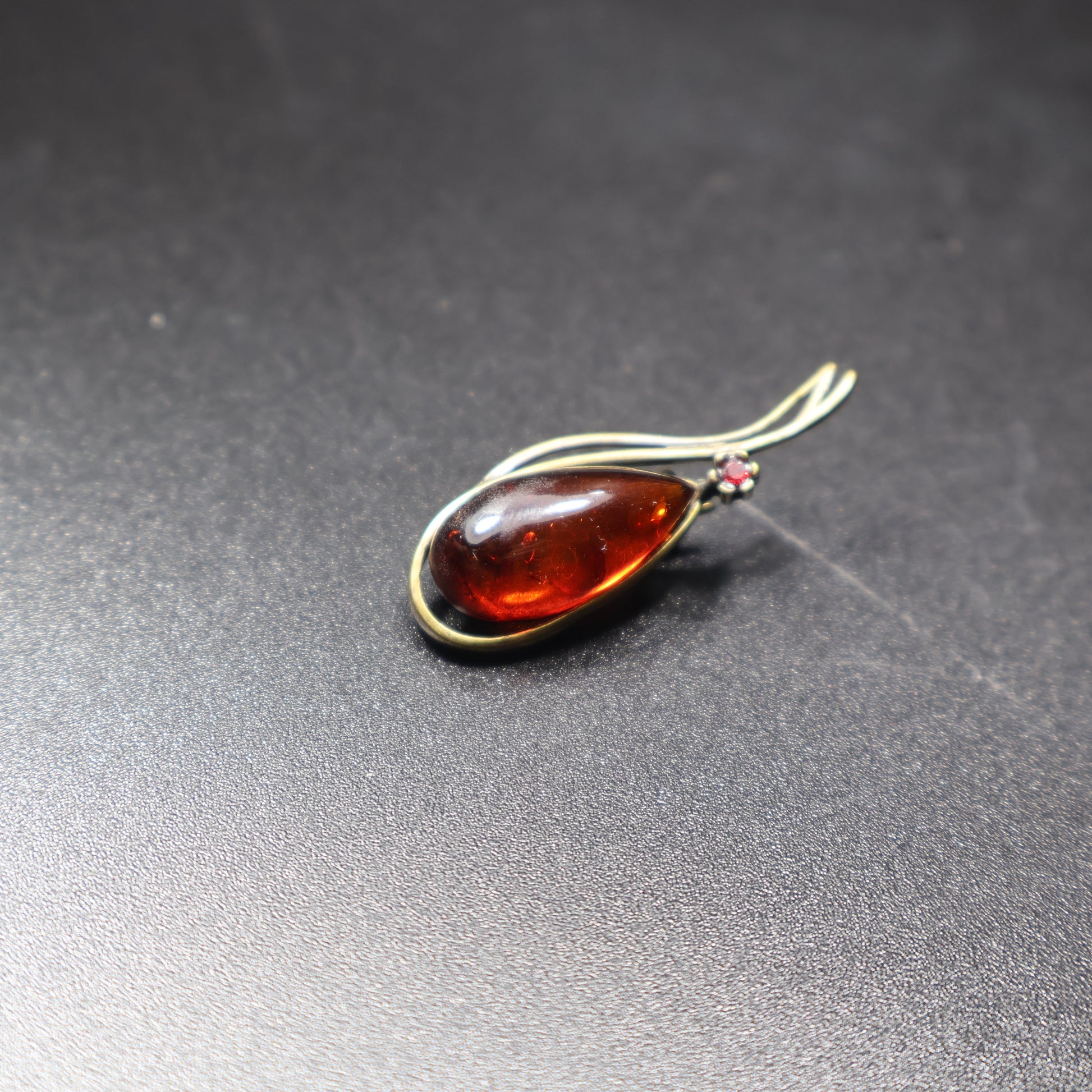 Handmade Baltic amber teardrop brooch close-up wire wrap detail