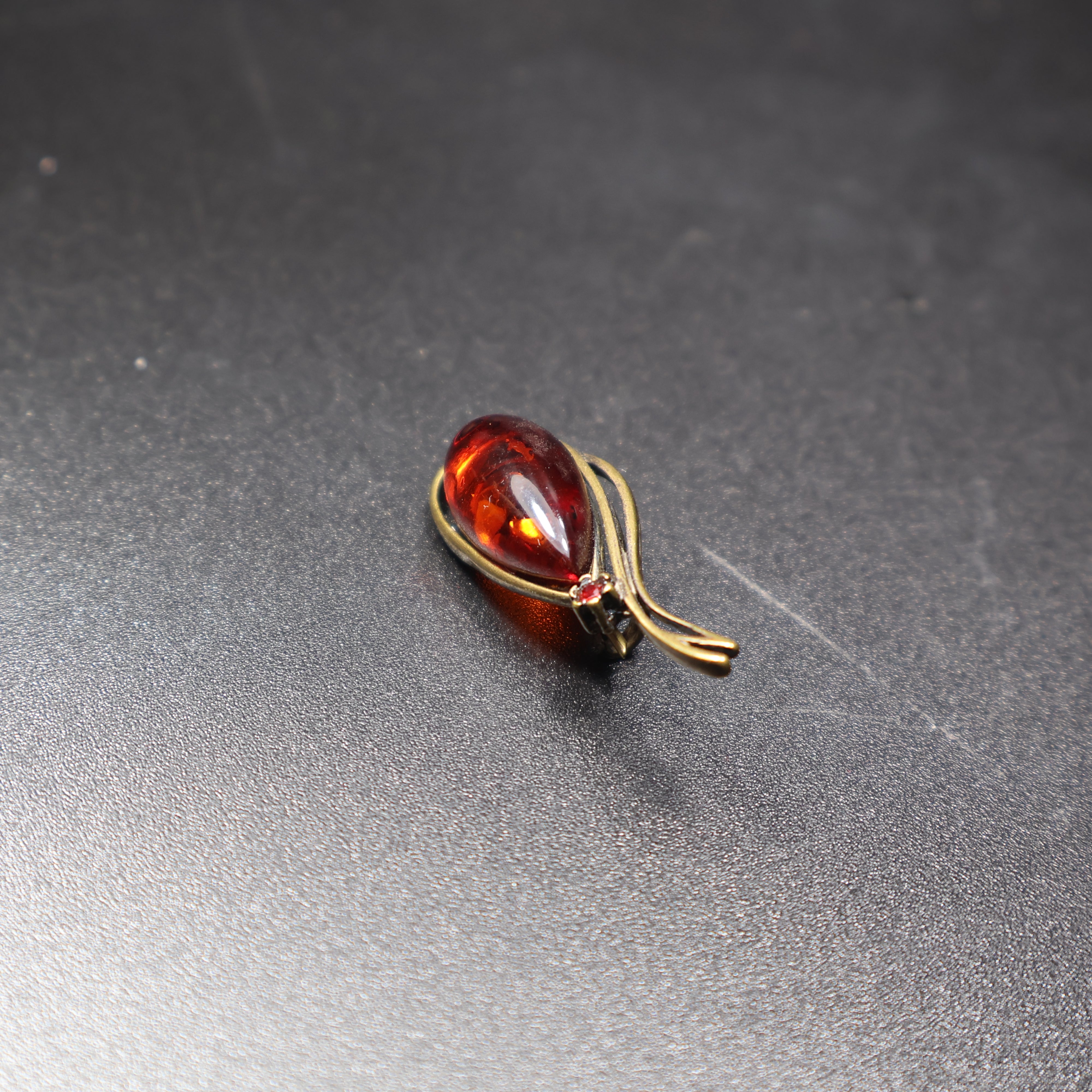 Genuine Baltic amber teardrop brooch side view showing setting