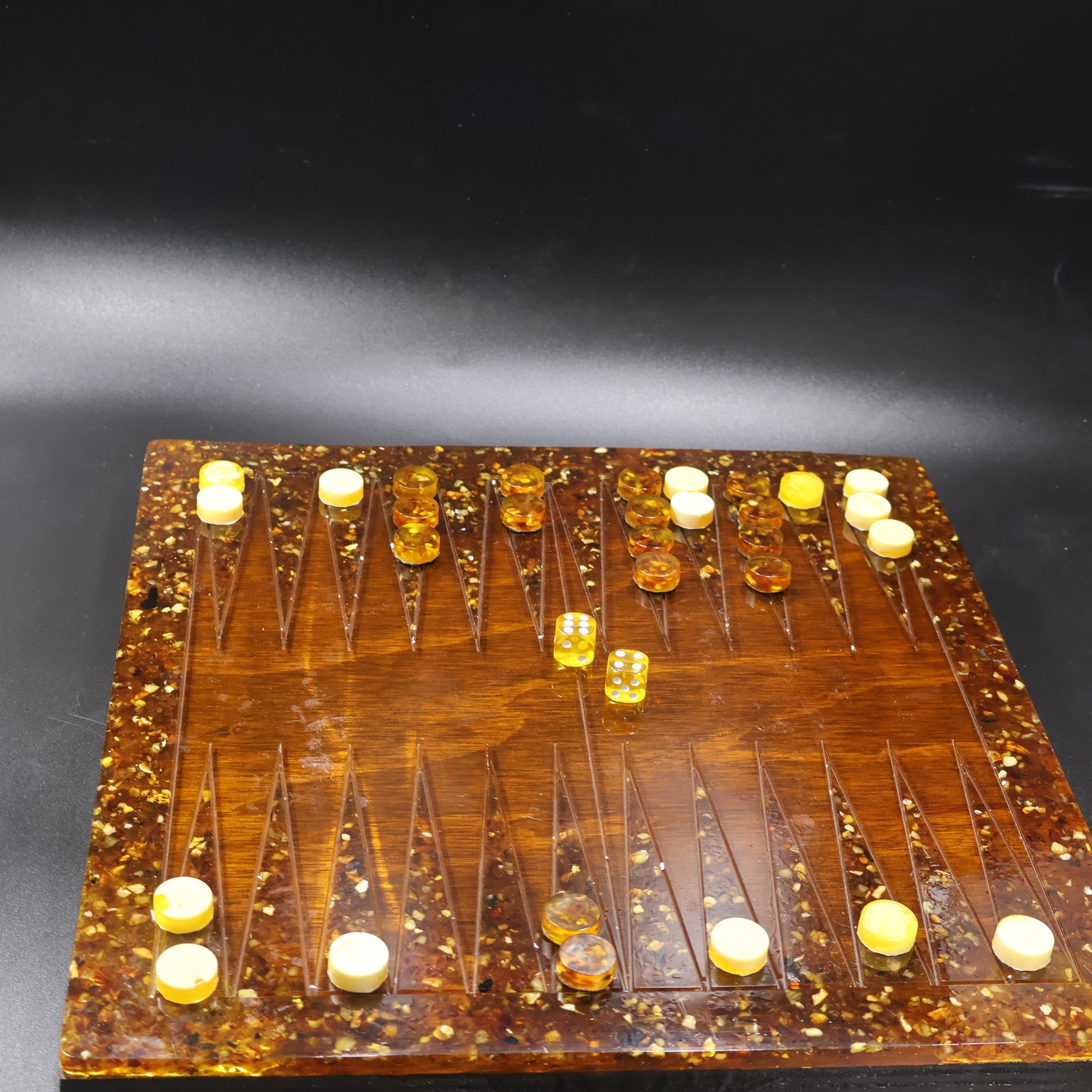 Natural Baltic amber backgammon checkers close-up cream and cognac