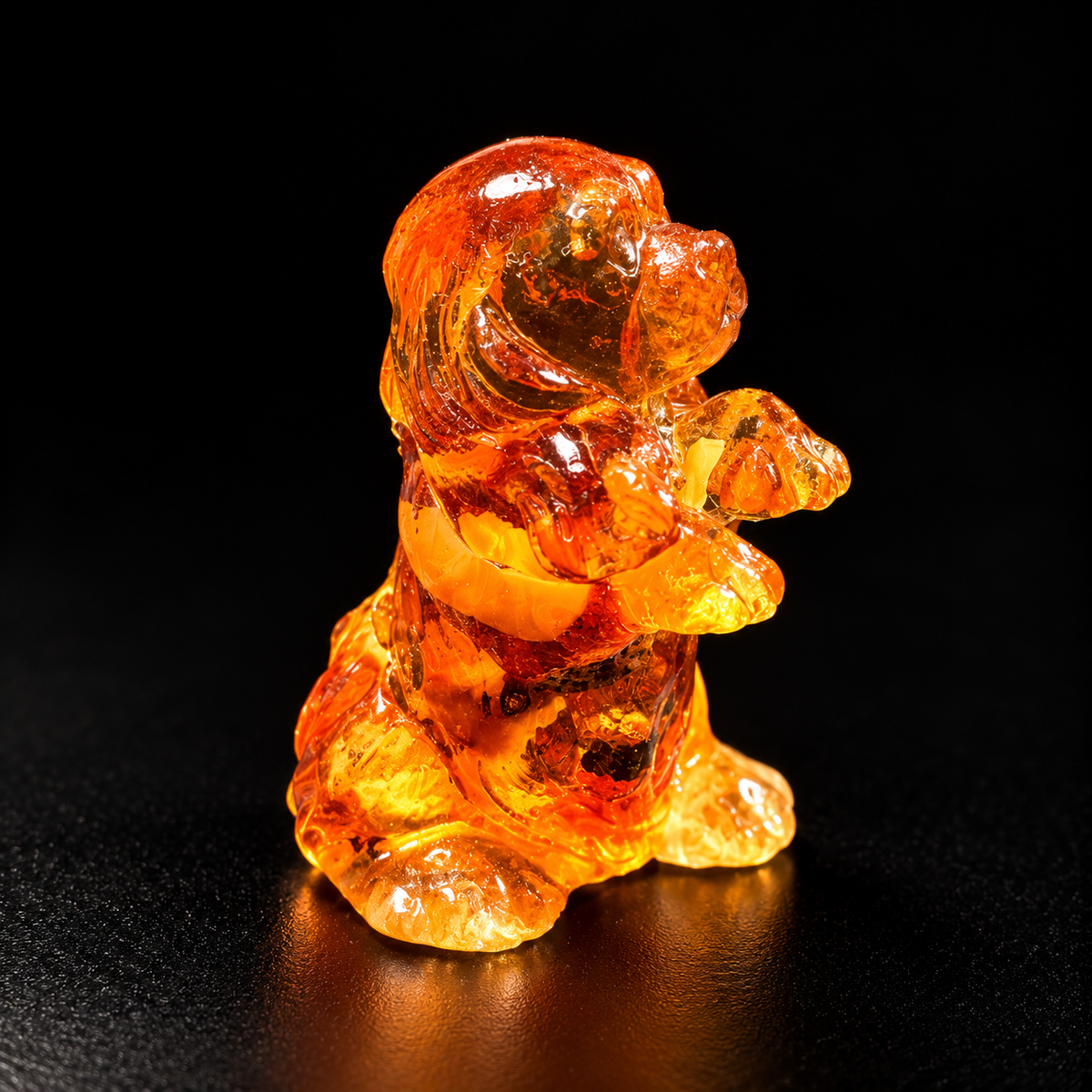 Made in USA natural Baltic amber begging puppy figurine, puppy sitting up on hind legs with paws raised glowing honey-cognac on black studio background — KIZIMA® Brooklyn NY