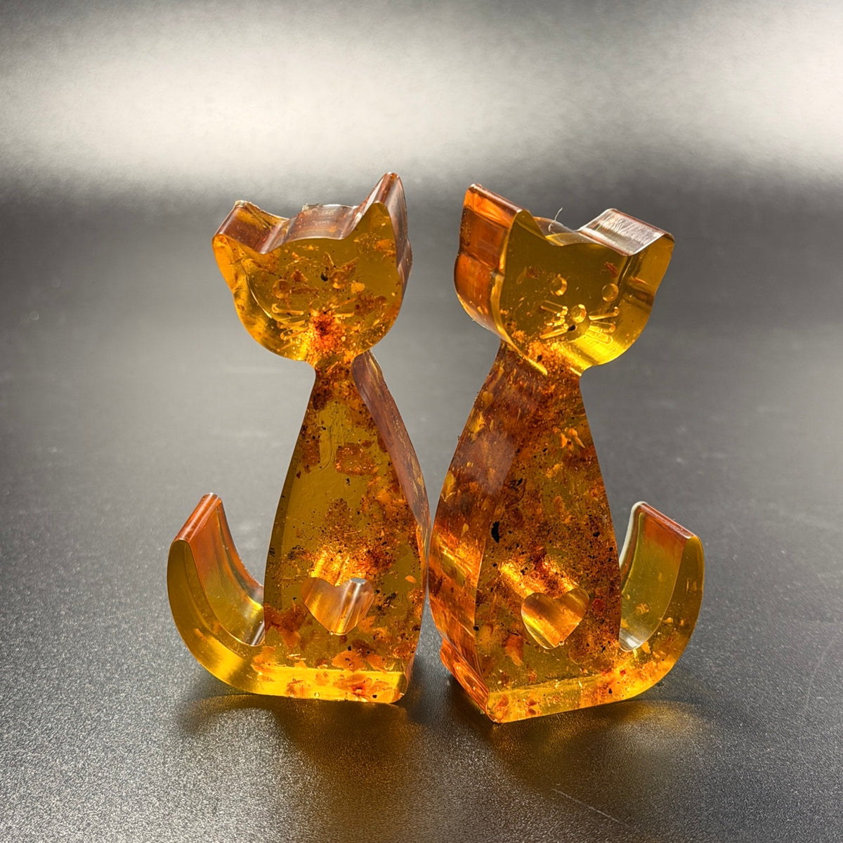 Made in USA natural Baltic amber cat figurines set of 2 — front view, honey amber cats with heart cutout by KIZIMA