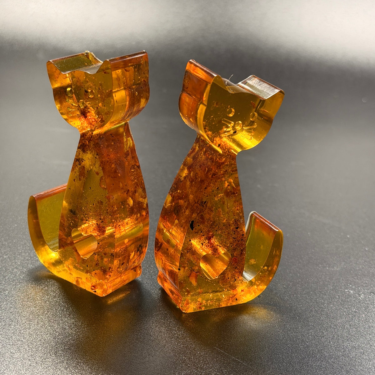 Back view of the amber cat couple figurines, handcrafted in Brooklyn from natural Baltic amber