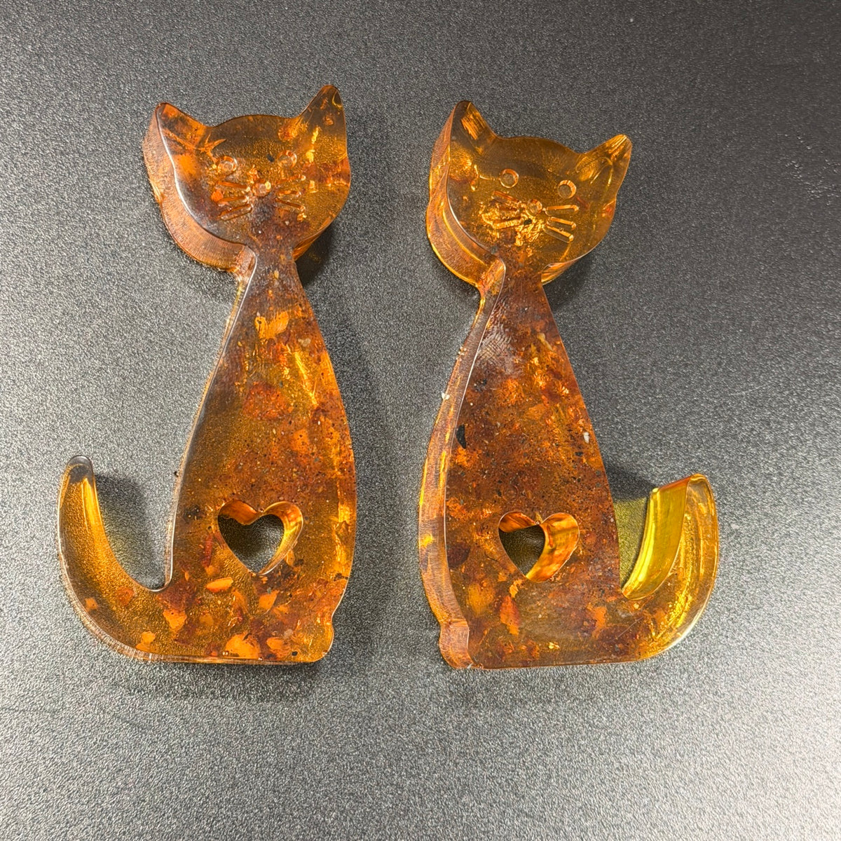 Close-up of natural Baltic amber cat figurines set, unique gift for wife or mom