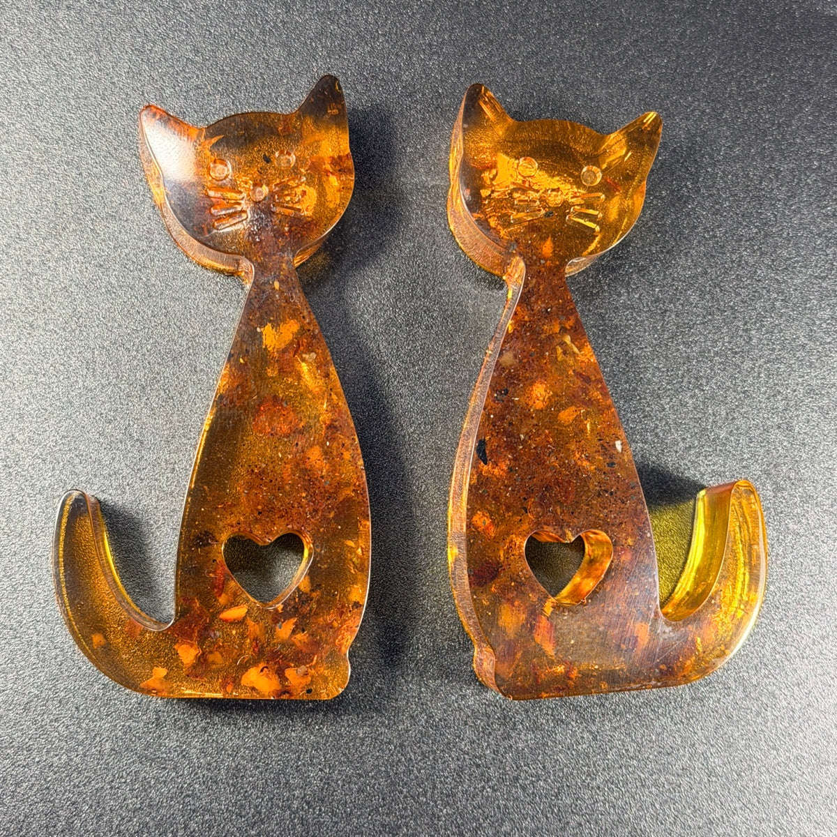 Amber cat figurines glowing in light — handmade in USA from genuine Baltic amber