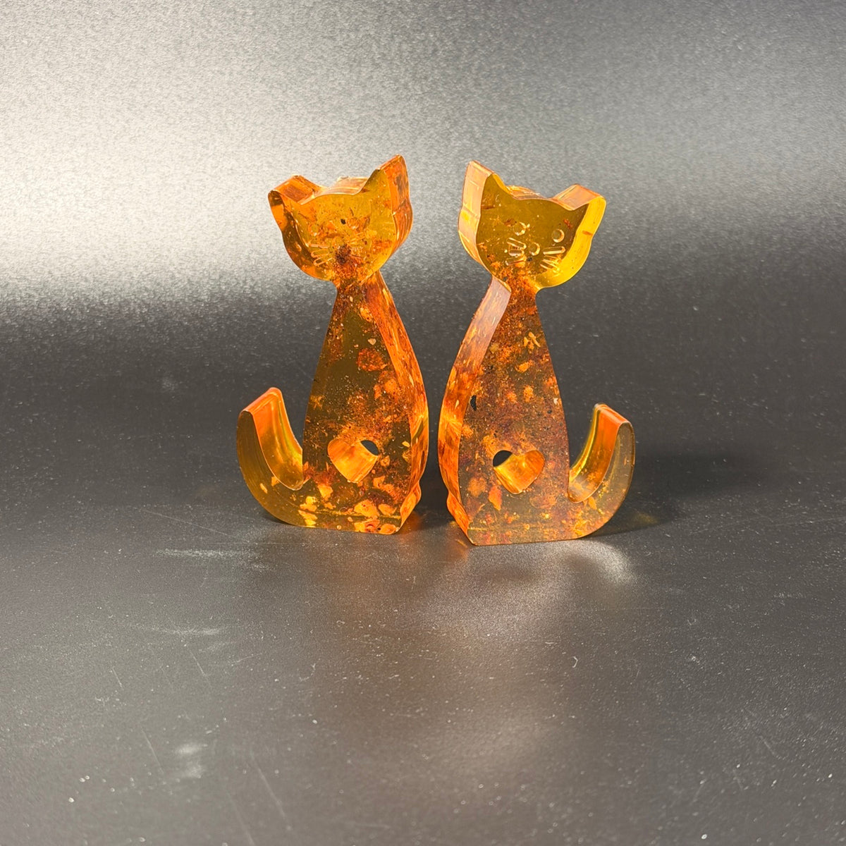 Detail of cognac amber inclusions in the handmade cat figurines by KIZIMA