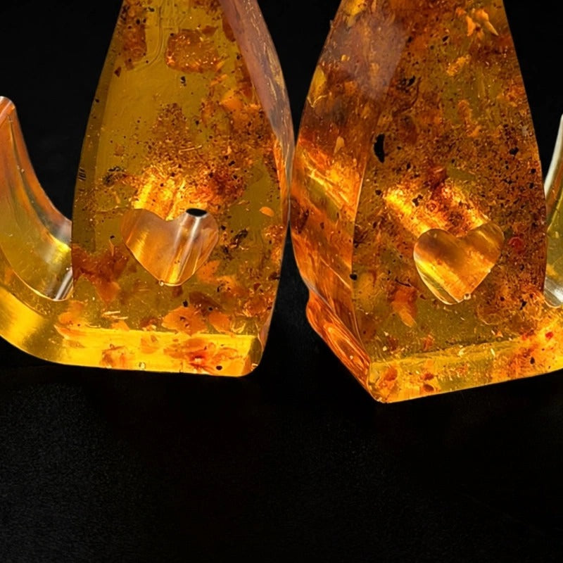 Close-up of the heart-shaped cutouts in the natural Baltic amber cat figurines — handmade in USA by KIZIMA