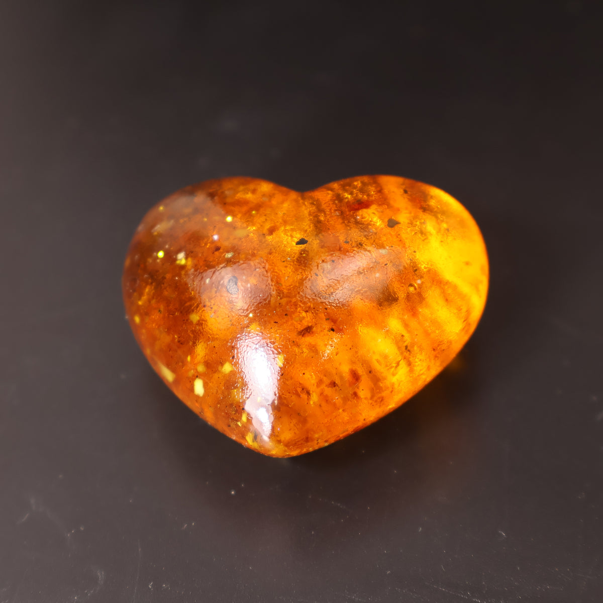 Baltic amber heart sculpture detail showing natural amber inclusions, handcrafted birthday gift for her by KIZIMA®
