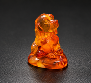 Made in USA natural Baltic amber Cocker Spaniel figurine, sitting spaniel on amber base glowing cognac-honey on black studio background, handcrafted by KIZIMA® Brooklyn NY