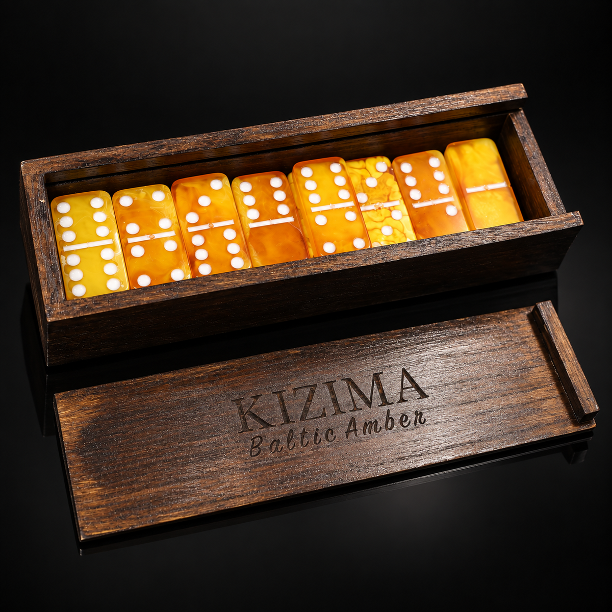 Natural Baltic Amber Domino Set with white pips in dark wooden box, KIZIMA® Baltic Amber lid engraving, black background — collectible game set handcrafted in Brooklyn, USA
