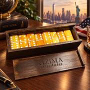 Made in USA Natural Baltic Amber Domino Set Double-6 by KIZIMA® in engraved dark wooden box on desk with New York skyline and Statue of Liberty — luxury handmade gift
