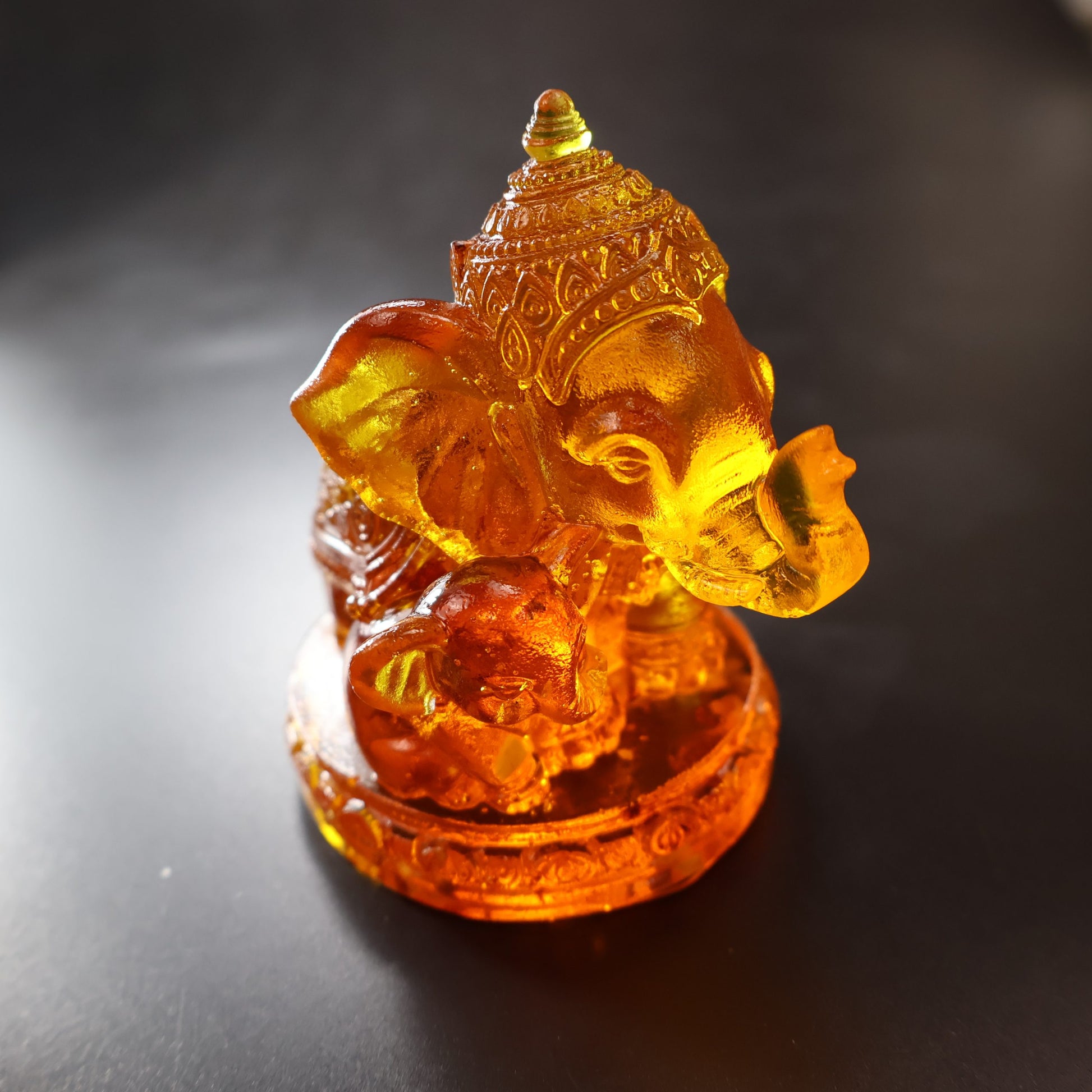 Handmade Baltic amber Ganesha statue close-up crown detail