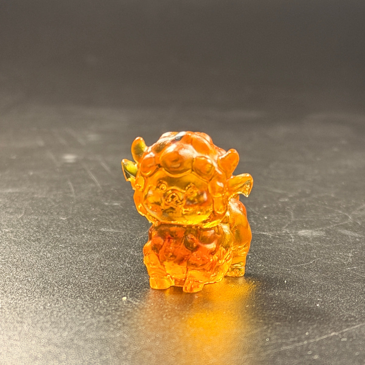 Front view of the genuine Baltic amber mini sheep figurine with curled fleece face and small horns, Made in USA by KIZIMA®