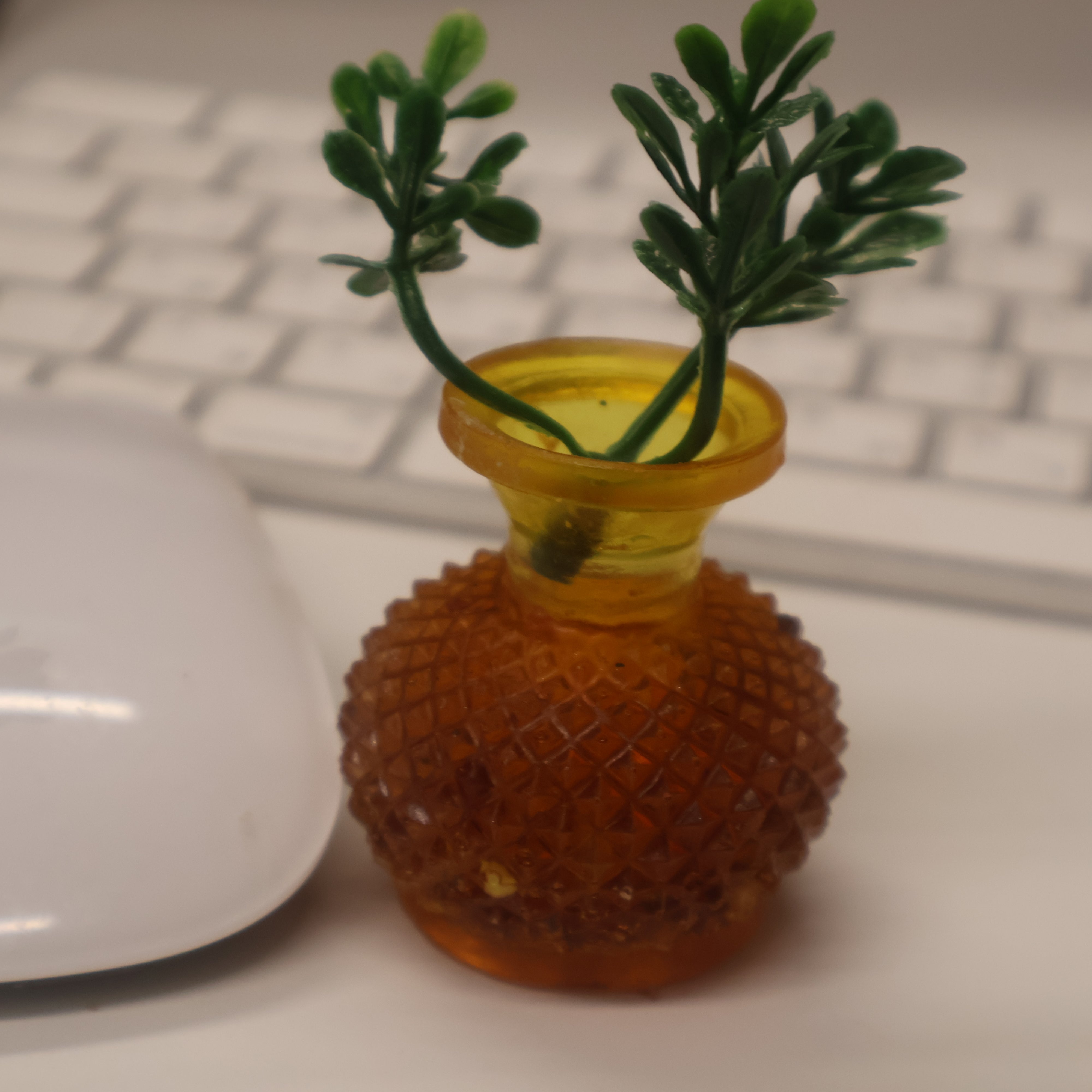 Natural Baltic amber mini vase next to computer mouse for scale, warm cognac amber desk decoration, KIZIMA®