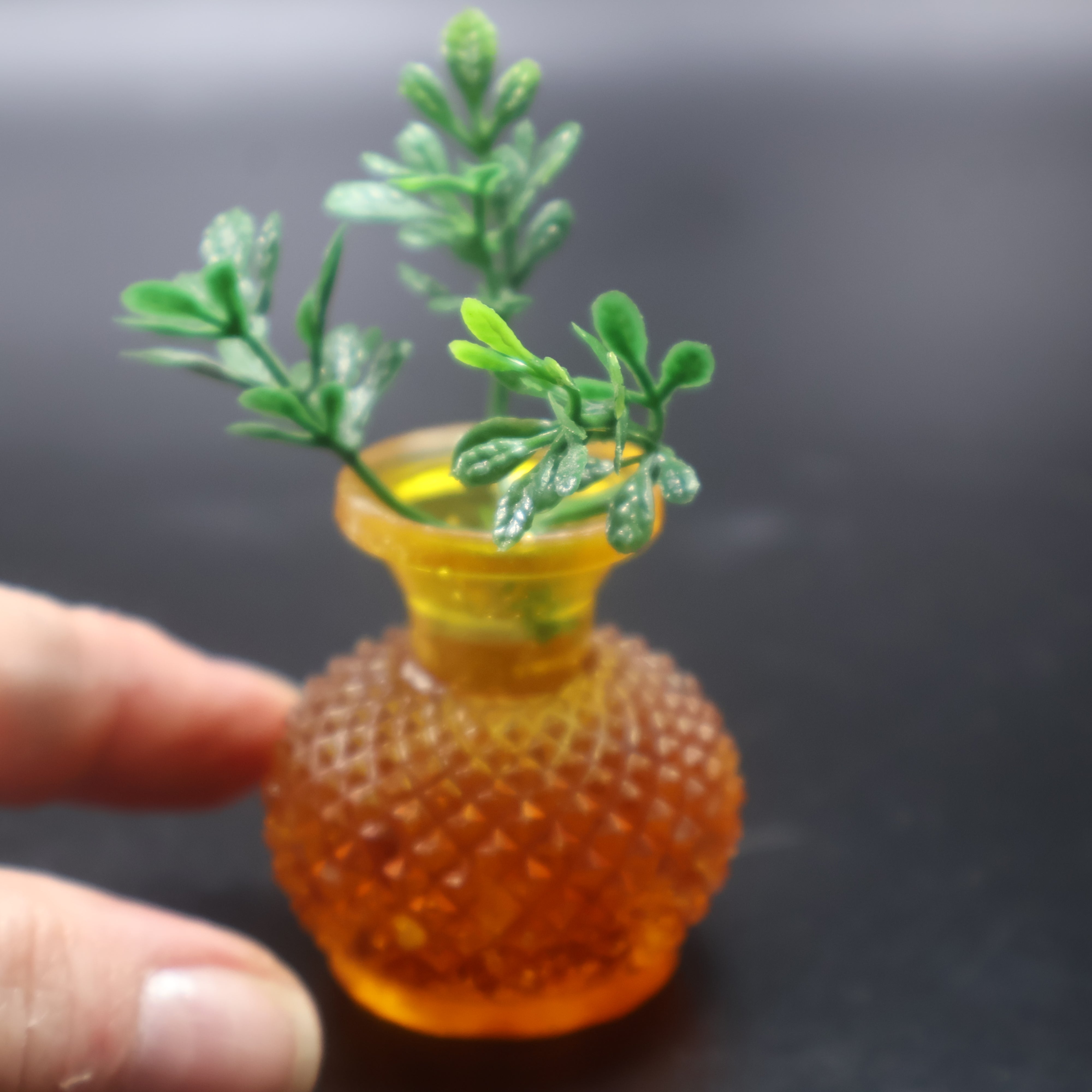 Mini natural Baltic amber vase held in hand for scale — tiny 4 cm amber bud vase handcrafted by KIZIMA® USA