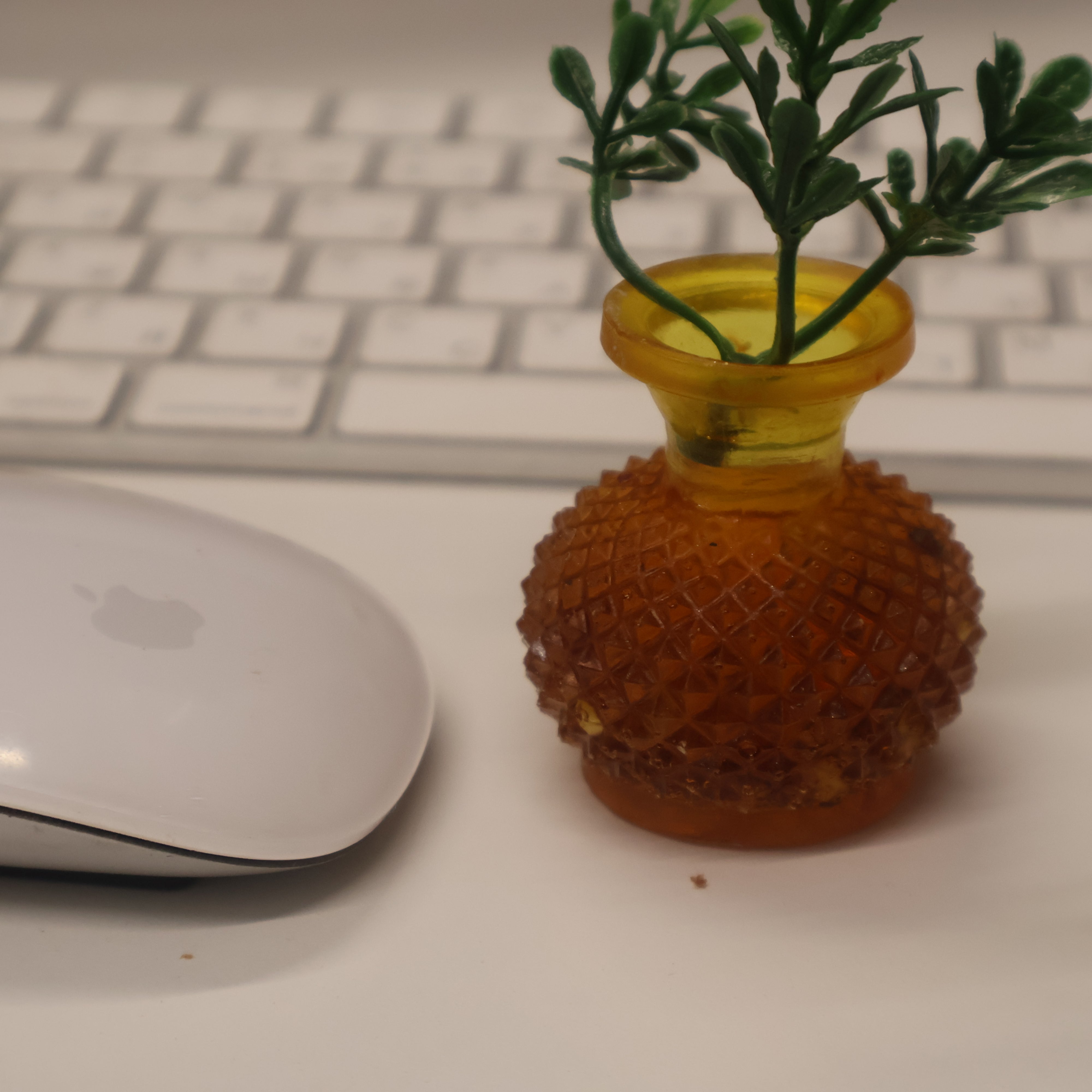 Tiny Baltic amber vase beside computer mouse showing miniature size — handcrafted amber gift, Made in USA by KIZIMA®