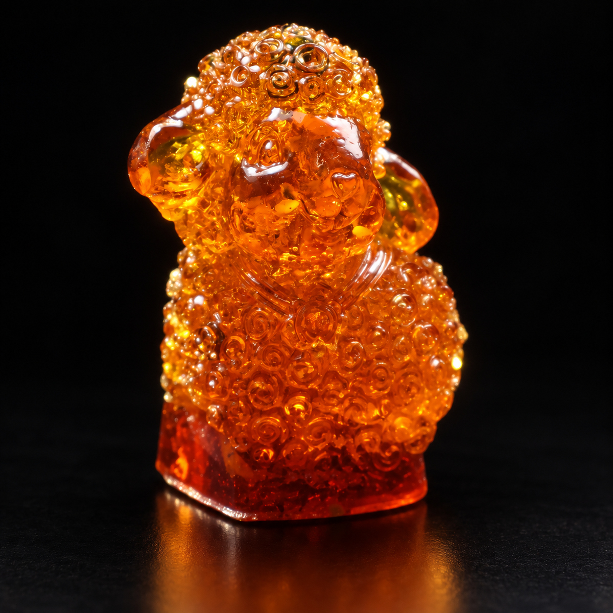 Made in USA Natural Baltic Amber nativity lamb figurine by KIZIMA® on a black studio backdrop, Christmas and New Year 2027 gift