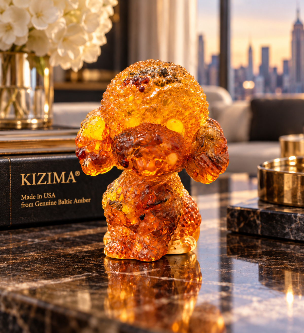 Made in USA natural Baltic amber poodle figurine on a desk with black KIZIMA® gift box and city skyline — poodle lover gift, handcrafted in Brooklyn NY