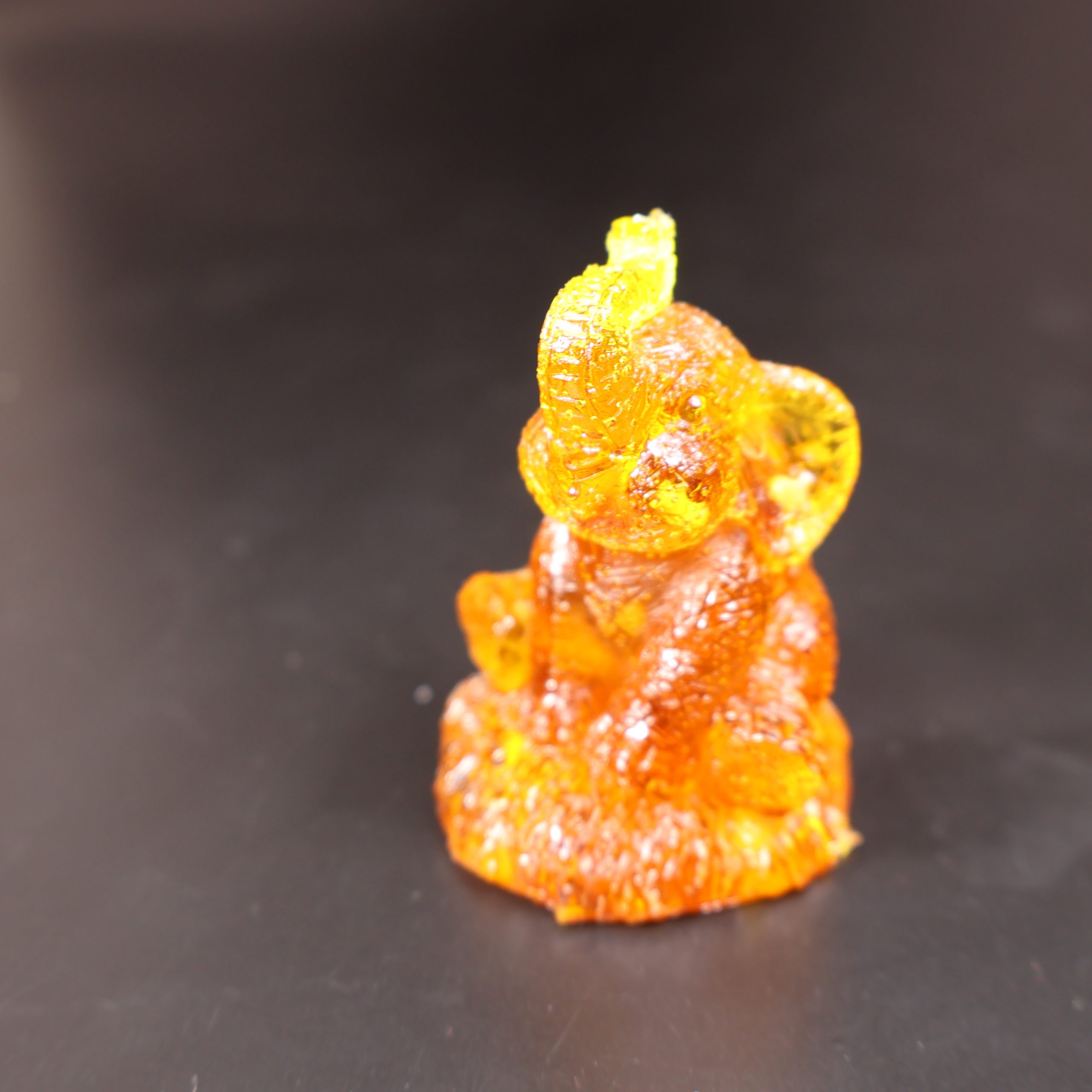 Handmade Baltic amber seated elephant figurine trunk up close-up
