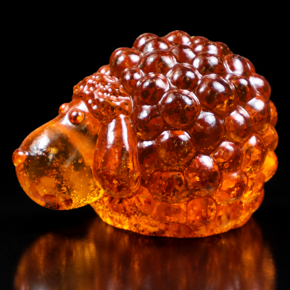 Made in USA Natural Baltic Amber sheep figurine with long nose and ears by KIZIMA® on a black studio backdrop, Christmas and New Year 2027 gift