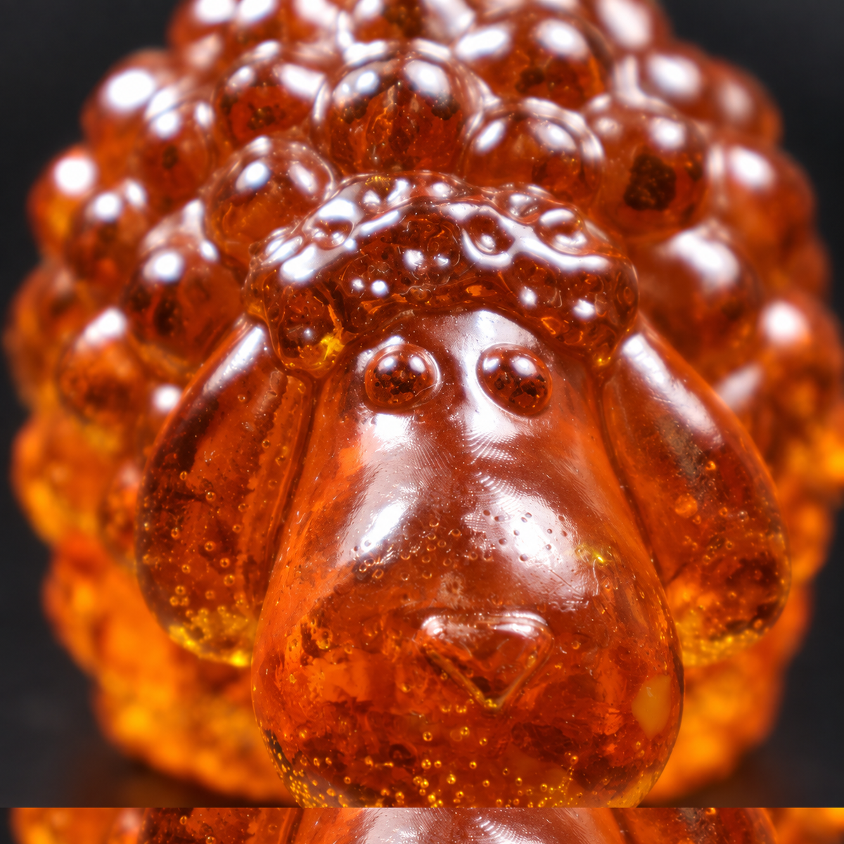 Macro detail of the sheep's long nose and ears in cognac and honey Baltic amber, Made in USA nativity keepsake by KIZIMA®