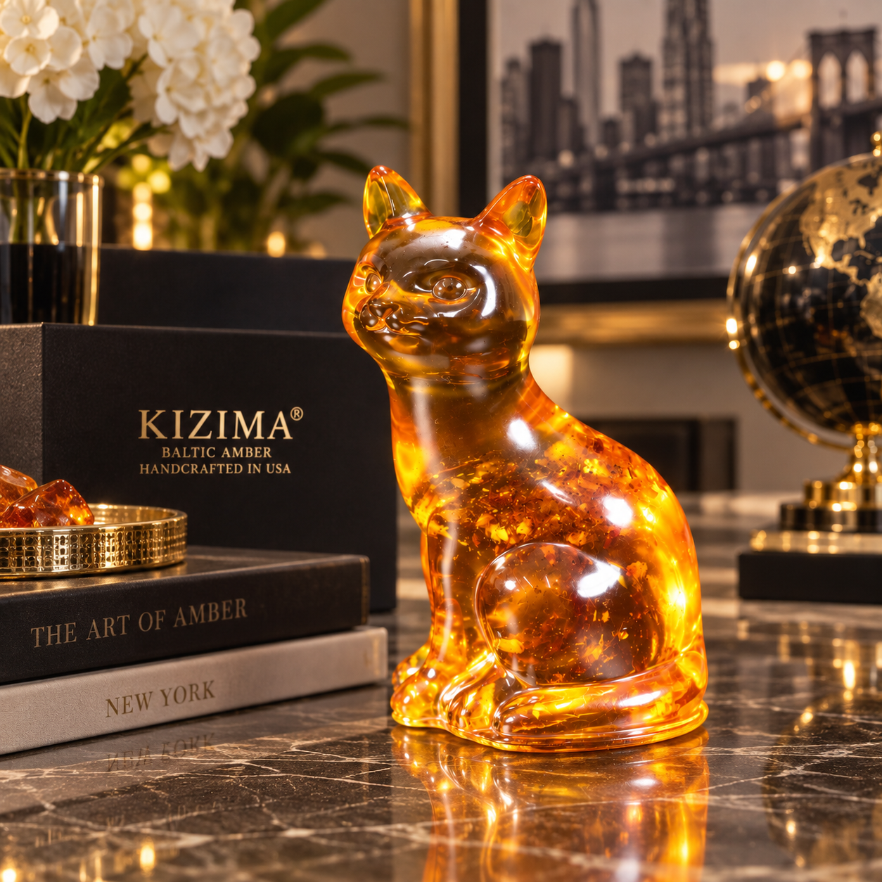 Handmade cognac Baltic amber cat figurine on a marble desk with KIZIMA® gift box — luxury cat lover decor, made in Brooklyn NY