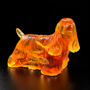 Made in USA natural Baltic amber standing Cocker Spaniel figurine, show-stance spaniel with long feathered coat glowing honey-cognac on black studio background — KIZIMA® Brooklyn NY