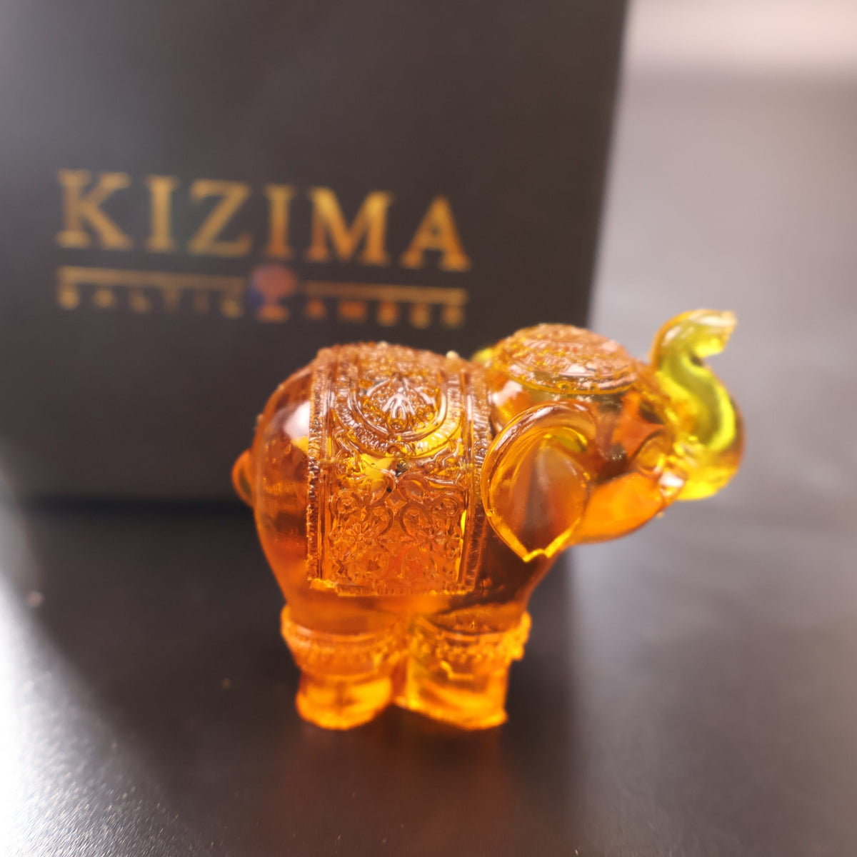 Genuine Baltic amber standing elephant figurine close-up detail