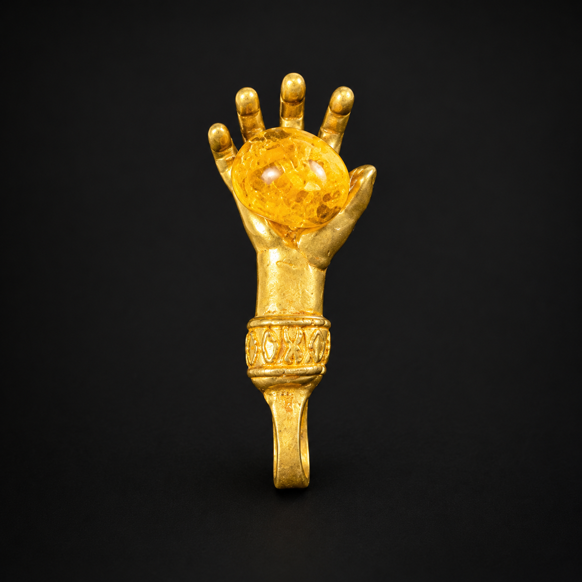 Made in USA Natural Baltic Amber money hand amulet by KIZIMA®, gold-tone metal hand holding yellow amber, black studio background