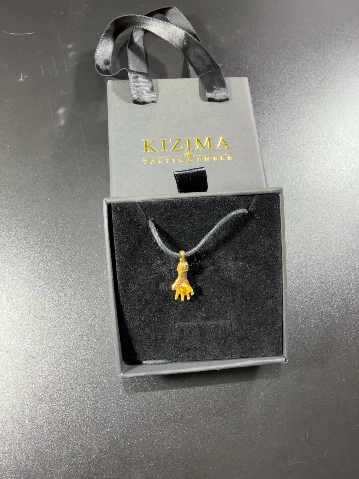 Made in USA Natural Baltic Amber money hand pendant by KIZIMA® in the drawer-style gift box with matching bag, original photo