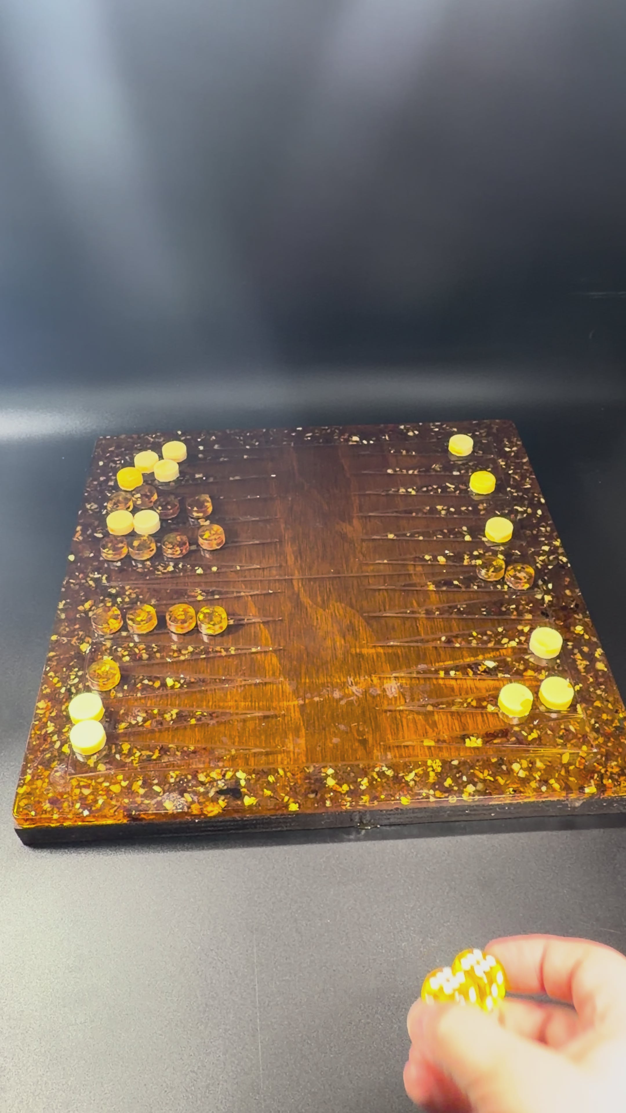Load video: Handmade Baltic amber backgammon board close-up video showing amber checkers